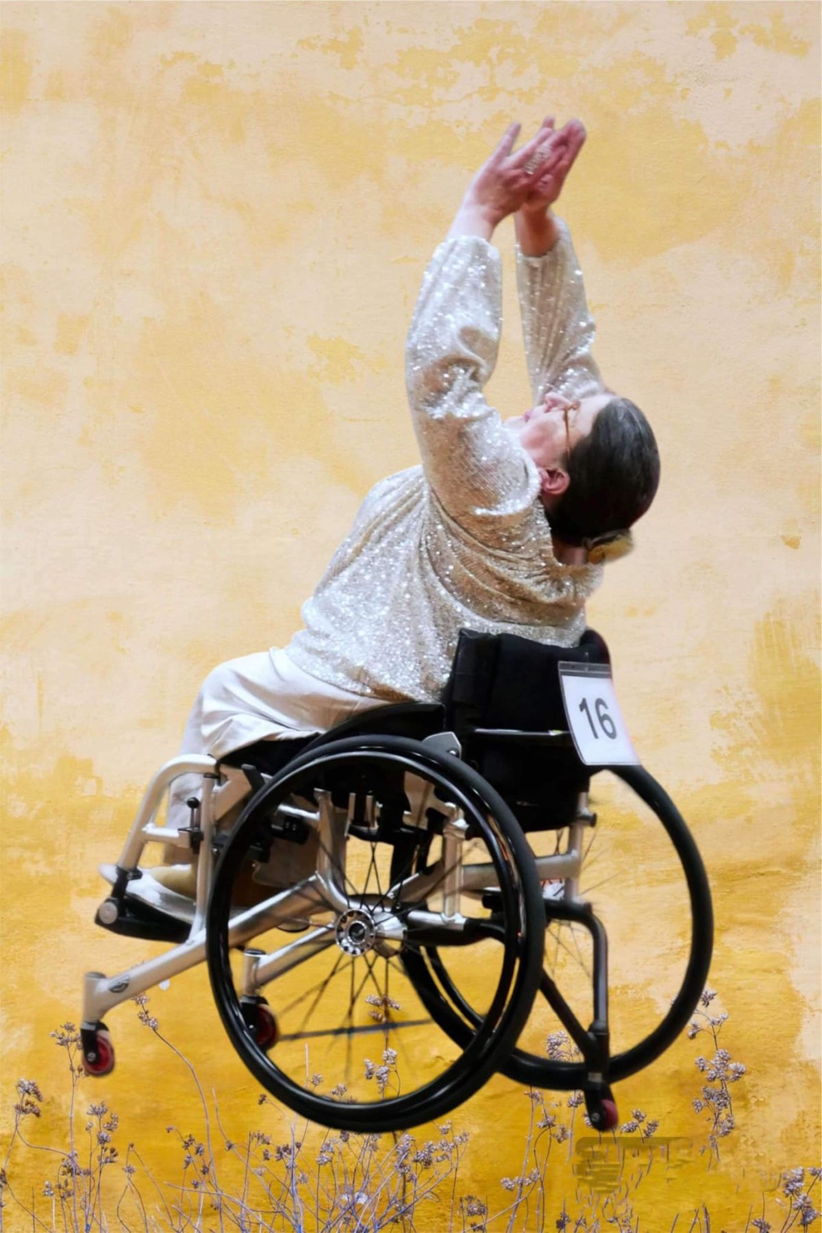 Sam Hall, in a white dress with her arms raised above her head, performing her freestyle routine.